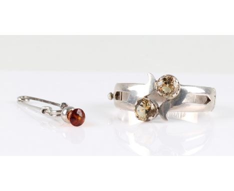 A citrine set bangle, together with a Scottish design kilt pin, (2).