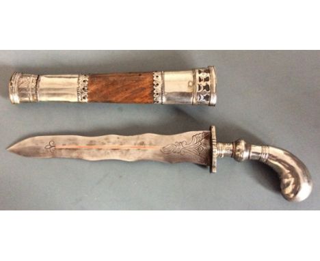 A Kris dagger with metal handle and walnut and metal scabbard.