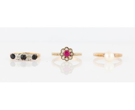 A 9ct yellow gold sapphire and diamond five stone ring, set with three round cut sapphires, measuring approx. 3mm each, separ