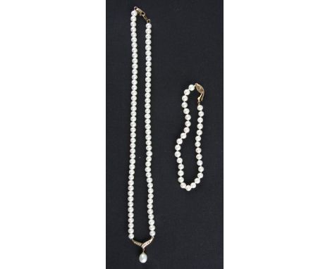 A string of pearls with dropper suspended from diamond set open metalwork, clasp stamped 375, length approx. 44cm, and a pear