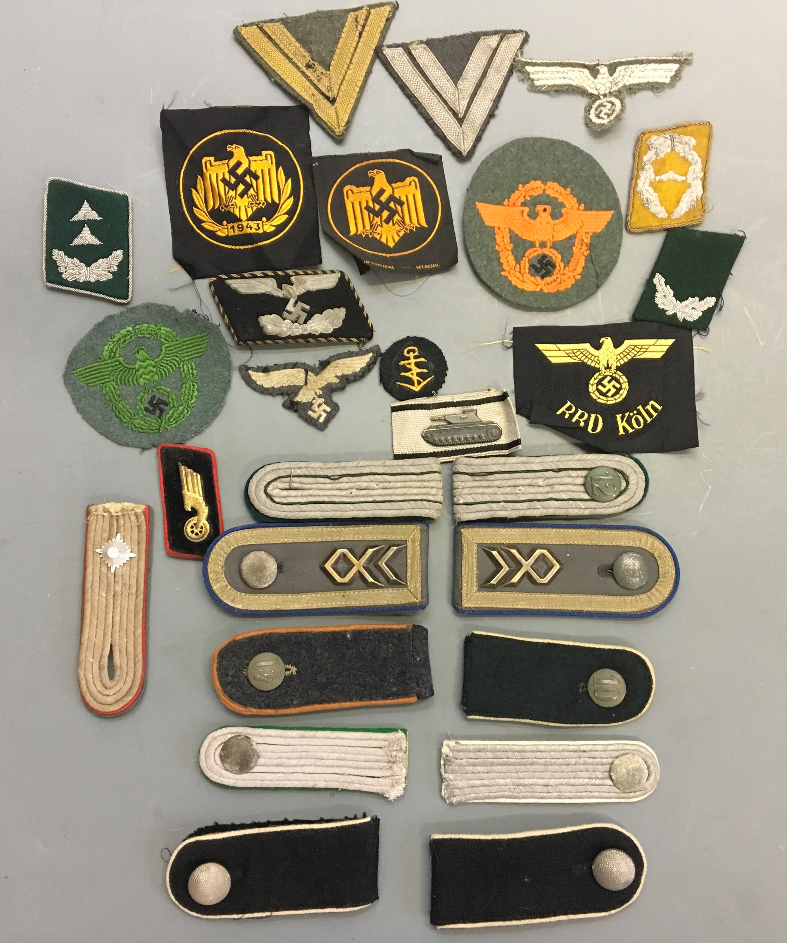 Various Nazi German cloth patches and shoulder straps.