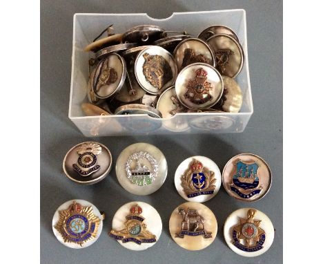 A collection of military sweetheart brooches mounted on mother of pearl.