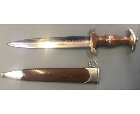 A SA Nazi German officers dagger with stained handle and brown scabbard marked with makers name Christanswerk to blade.