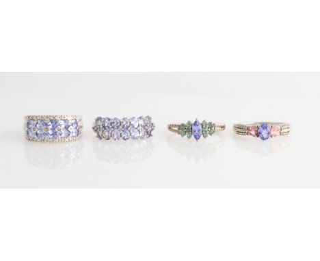 Four tanzanite rings, two of which are set with additional coloured gemstones, all stamped 925, ring sizes O and N½.
