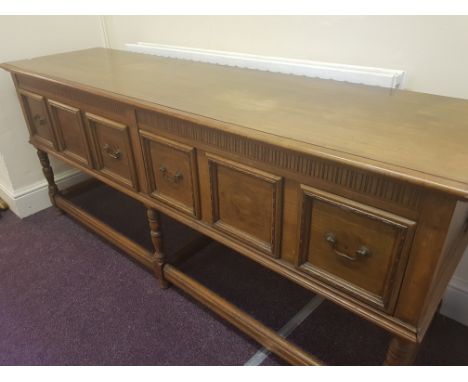 A Mahogany J K Rishel large two drawer dresser base with six turned legs and stretcher supports.