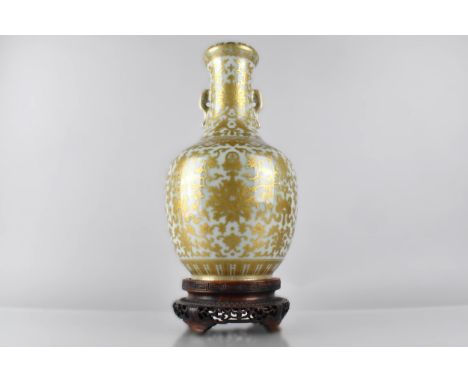 A Chinese Porcelain Celadon Ground Twin Handled Vase of Bottle Form Profusely Decorated in Gilt Detailing Vines, Bats and Ruy