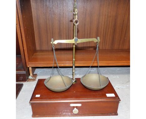 A pair of 19th century brass balance scales on a mahogany plinth with drawer and a boxed set of scientific weights