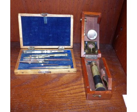 A brass field microscope in mahogany case; a cased set of geometric instruments