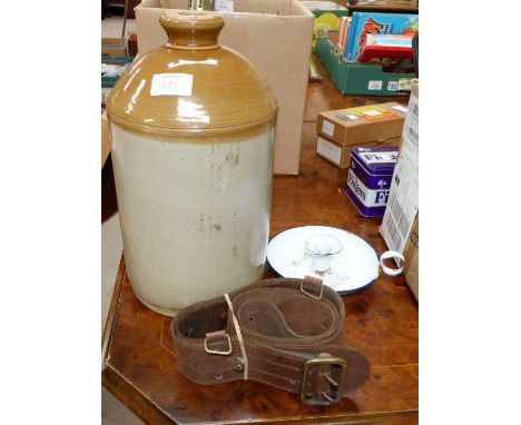 A stoneware rum flagon, an enamel candlestick, officer's belt