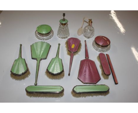 A quantity of pink and green enamel backed dressing table items to include two perfume bottles 