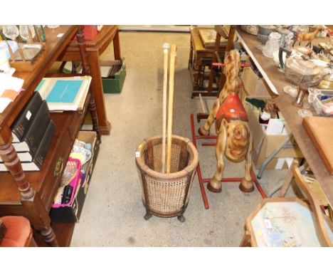 A mahogany and cane stick stand and contents of two sticks 