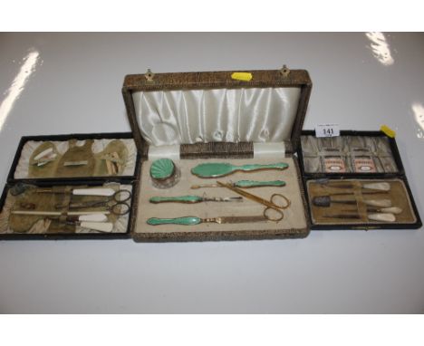Two cased vintage sewing kits; and an enamel decorated manicure set