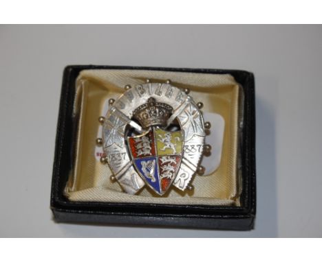 An 1886 B Bros Golden Jubilee silver and enamel brooch