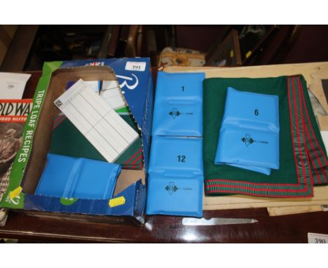 A box of bridge related items, score cards, playing cards, baize etc.