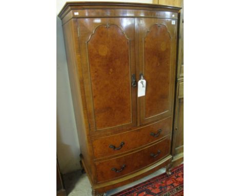 Reproduction walnut bow fronted, two door linen press type cupboard on cabriole legs.(B.P. 24% incl. VAT)