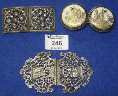 Two silver pierced belt buckles, together with plated bird and foliate decorated ceramic belt buckle.(B.P. 24% incl. VAT)