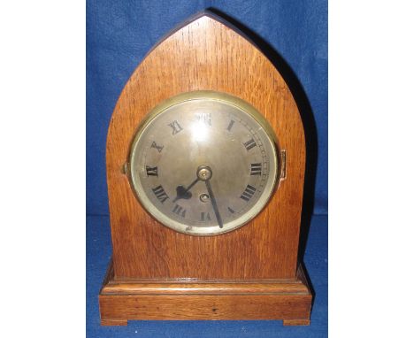 Early 20th Century oak lancet shaped mantel clock with silvered Roman face and single train movement, 36cm high.(B.P. 24% inc