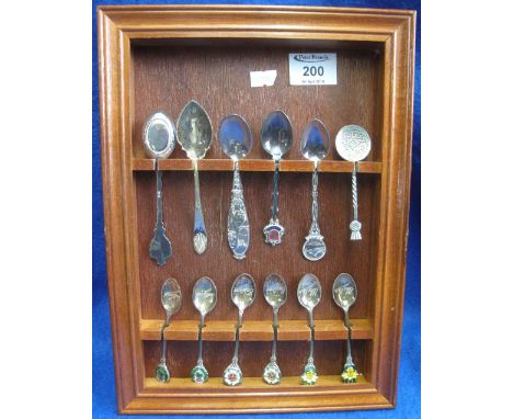 Wooden spoon rack containing assorted silver and plated collectors spoons, some with enamel terminals.(B.P. 24% incl. VAT)