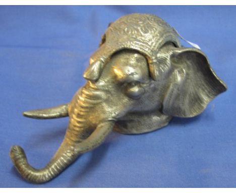 Plated metal inkwell in the form of an elephant's head with hinged cover revealing ceramic well. 12.5cm(B.P. 24% incl. VAT)