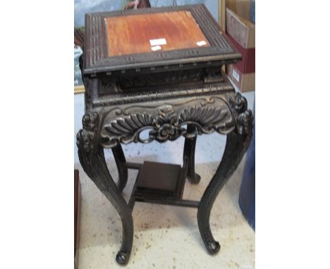 Chinese style ebonised and carved jardiniere stand with under shelf, standing on cabriole legs.(B.P. 24% incl. VAT)