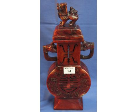 Chinese design polished and gilt inlaid red hardstone, two handled, pierced flask and cover, the cover with Dog of Fo, mythic