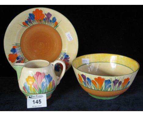 Three pieces of Clarice Cliff Pottery in crocus pattern, the sugar bowl stamped: 'Bizarre Crocus Wilkinson', the plate stampe