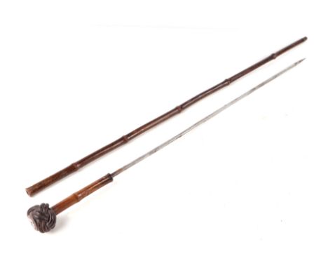 A German pre 1947 bamboo sword stick, the pommel with a Nazi party enamel badge, 86cm long. 