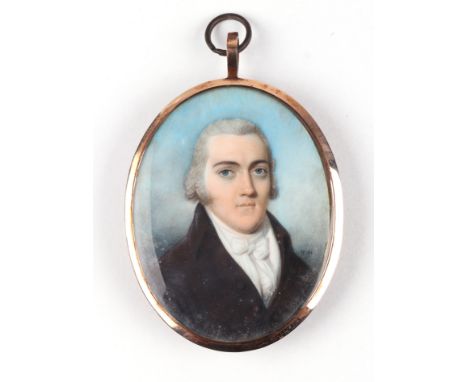 A late 18th / early 19th century yellow metal mounted oval portrait miniature on ivory depicting a young gentleman wearing a 