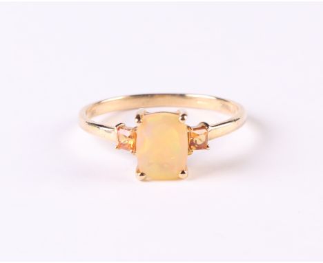 A 10ct gold ring set with a central opal flanked by two orange stones, approx UK size 'P', 1.6g.