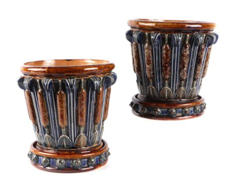 A pair of Doulton Lambeth jardinieres on stands decorated with bulrushes, both with potter's initials, one being 'EP' for Emi