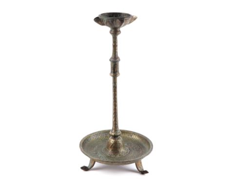 An Indian bronze temple Puja oil lamp, the base decorated with stylised fish and calligraphy, 40cms high.