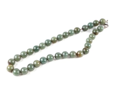 A green jade bead necklace, 46cm long, bead diameter 11mm