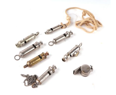 A group of vintage whistles to include a military example dated 1945, another surmounted a compass, an ARP example and other 