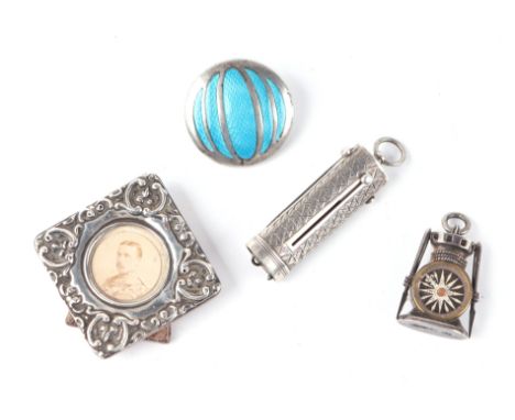 A group of small silver items to include a silver charm in the form of a ship's lantern set with a compass; a silver and enam