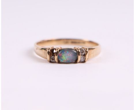 A 9ct gold ring set with a central opal flanked by cubic zirconia, approx UK size 'O', 1.8g.Condition ReportOne cubic zirconi