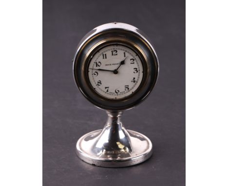 An early 20th century silver dressing table clock, the white dial with Arabic numerals, 7cms diameter, Birmingham 1923.Condit