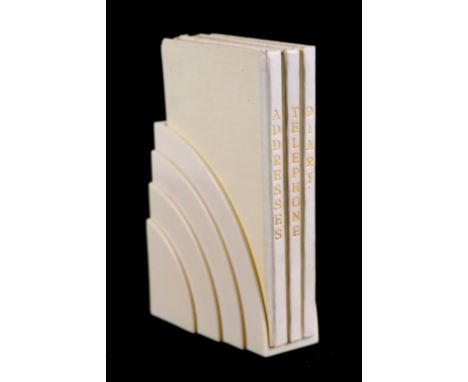 A Dunlop (Footwear) Art Deco Bakelite Diary and notebook stand containing three notebooks for telephone, diary and addresses,