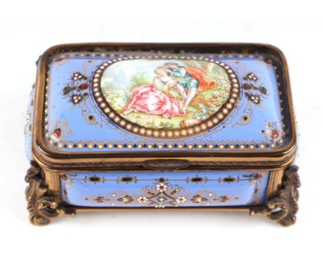 A 19th century French enamel and ormolu mounted trinket box with blue ground and jewelling, the top decorated with an oval pa