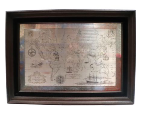 A Royal Geographical Society sterling silver world map, 56 by 38cms, framed.