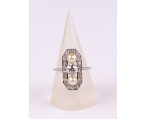 An Art Deco platinum (tested) diamond and pearl cluster ring of rectangular form with cut corners, the central old cut brilli