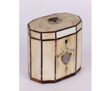 A George III ivory veneered tea caddy of decagon form with tortoiseshell stringing, mother of pearl inlay and a shield shaped