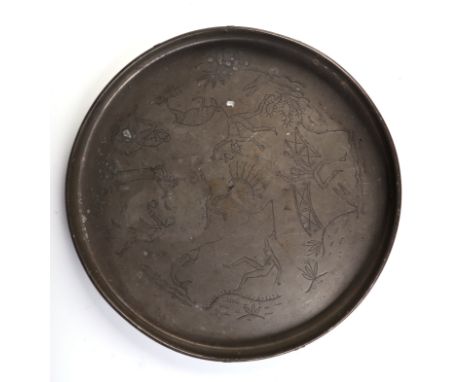 A Swedish Svenskt Tenn circular pewter tray, with folk art wriggle work decoration depicting figures and animals, engraved to