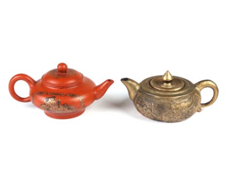 A Chinese Yixing teapot decorated with erotic scenes, character mark to base; together with a gilt metal teapot decorated wit