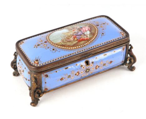 A 19th century French enamel and ormolu mounted trinket box with blue ground and jewelling, the top decorated with an oval pa