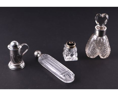 A silver mounted perfume bottle, 11cms high; together with a silver topped scent bottle, 12cms long; a silver pepper pot, 6.5