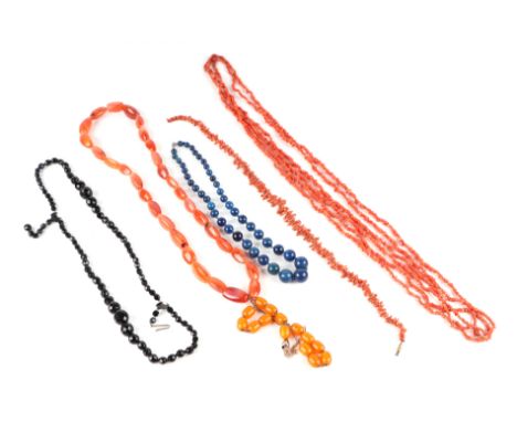 Two stick coral necklaces, a set of amber like worry beads, a lapis lazuli bead necklace and other items. 