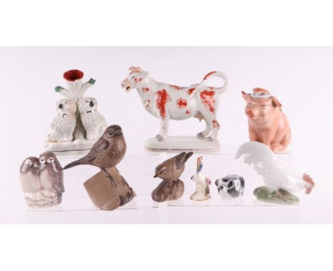 A Collection of Victorian and later ceramic figures to include Royal Copenhagen, a cow creamer, Poole Pottery and Sue & Richa