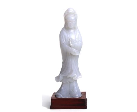 A Chinese jade figure depicting Guanyin, 13cms high.