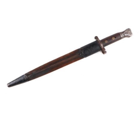 A WWI bayonet with 30cms steel blade, signed 'Wilkinson London', with metal and leather scabbard.