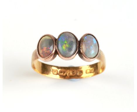 A 22ct gold ring set with three oval opal cabochons, approx UK size 'P', 2.4g.